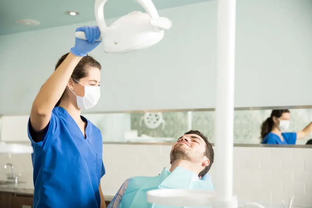 A dentist preparing to treat a patient